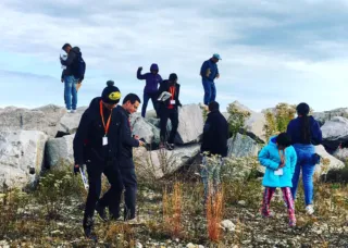 Students climbing on boulders