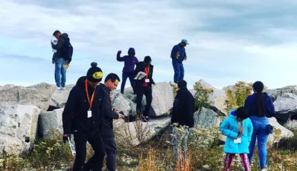 Students climbing on boulders