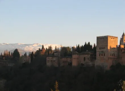 A photo of the Alhambra against the backdrop of snow-capped mountains