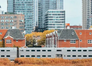 View of open space, train line, and residential buildings in Chicago, IL