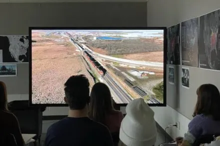 Students viewing video on 86" 4K interactive touch sccreen monitor.