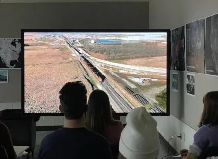 Students viewing video on 86" 4K interactive touch sccreen monitor.