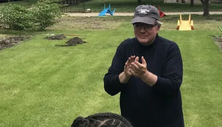 Photo of Ron Henderson in a garden