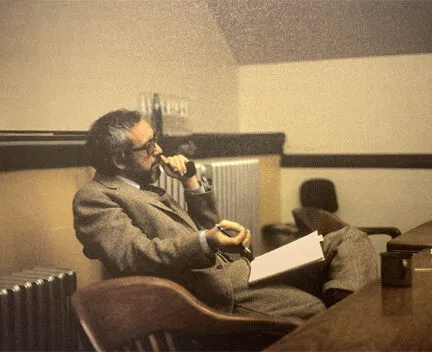 Photo of Robert B. Riley seated at a table in Mumford Hall in 1977.