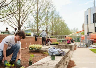 people outdoors gardening