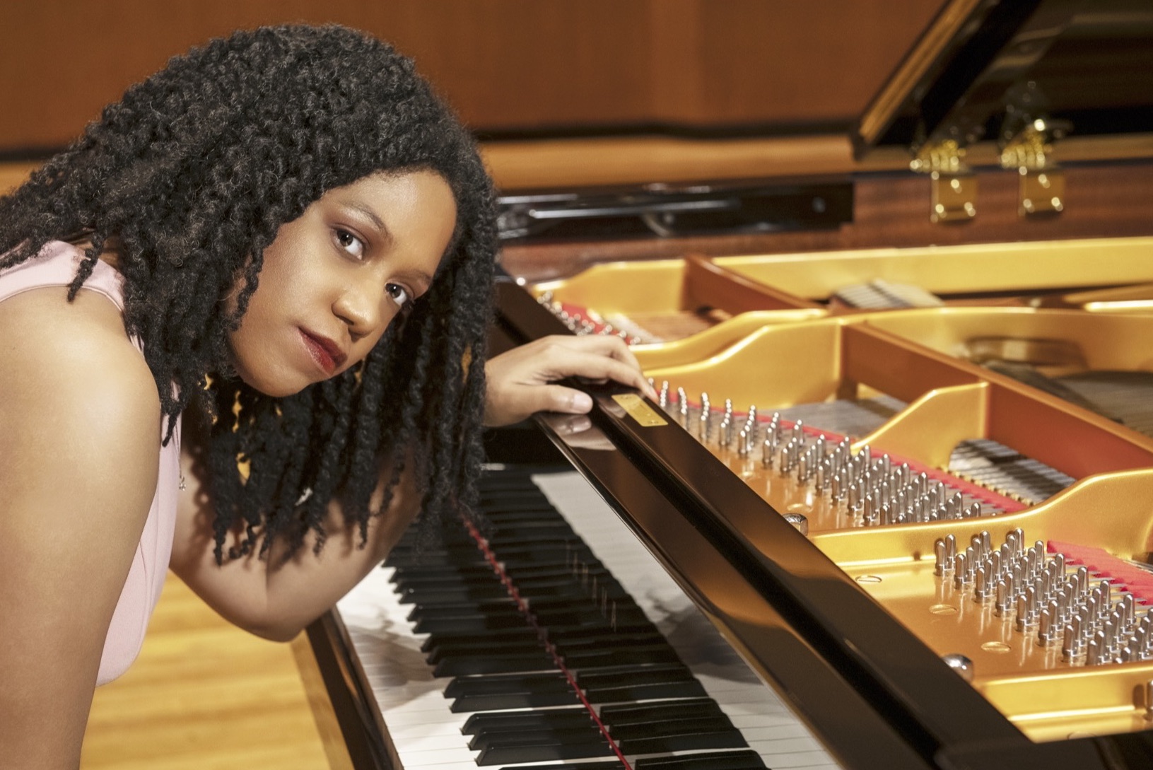 person with piano looking at camera