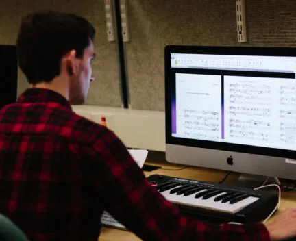 A student works at a computer.