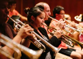 Picture of several students playing the trumpet.