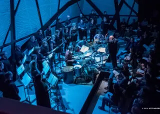 chorus performing in blue light