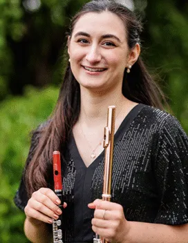 Julia Escobar holding a flute and piccolo