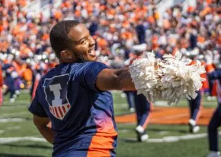 Jeremiah Jordan, junior in FAA, performs alongside the Illinettes dance team at a football game on Sept. 27. Jordan is a dance major, and he is the first male member of the Illinettes. Photo by Sam Rink, The Daily Illini