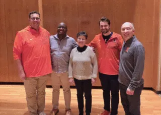 The photo below includes the three wind conducting TAs who conduct Campus Band, Alex Mondragon, JaQuan Wiley, and Beau Bujol, alongside Kathy and director of bands Kevin Geraldi.