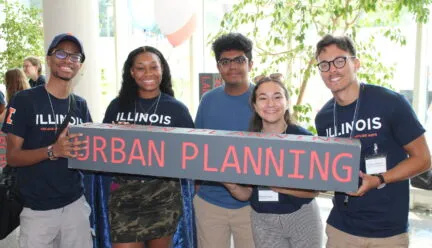 5 students standing holding "urban planning" sign