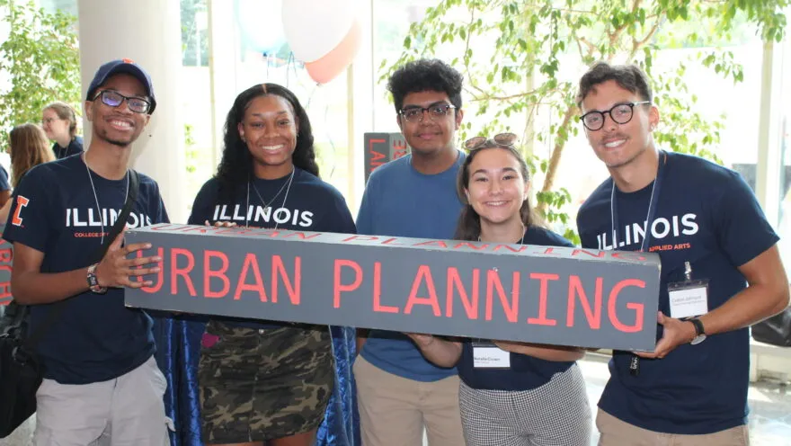5 students standing holding "urban planning" sign