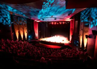theatre filled with people and lights