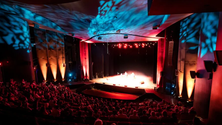 theatre filled with people and lights