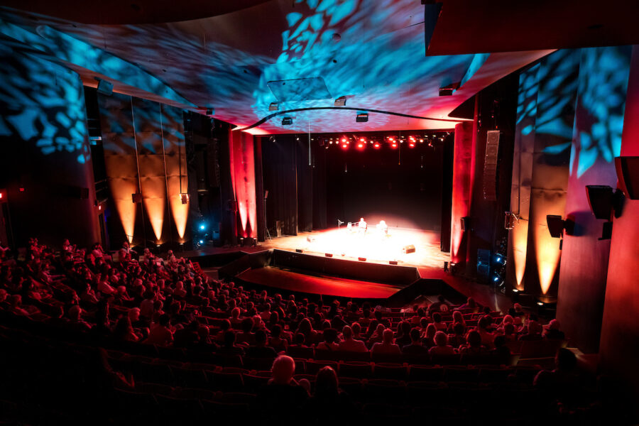 large proscenium theatre with audience in seats