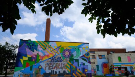 Peoria mural on side of brick building featuring lots of bright colors