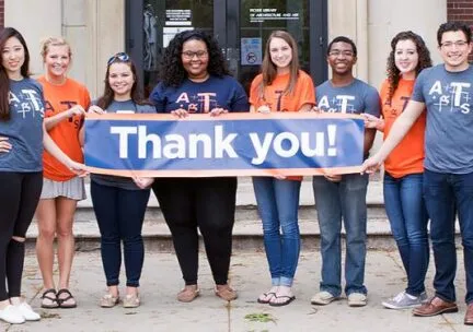 students holding thank you banner