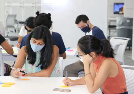 people in masks working at tables