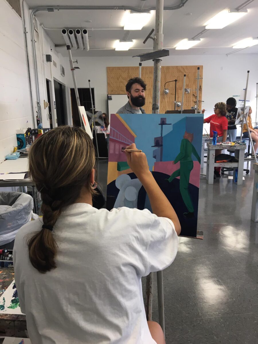 Student creates a painting in studio