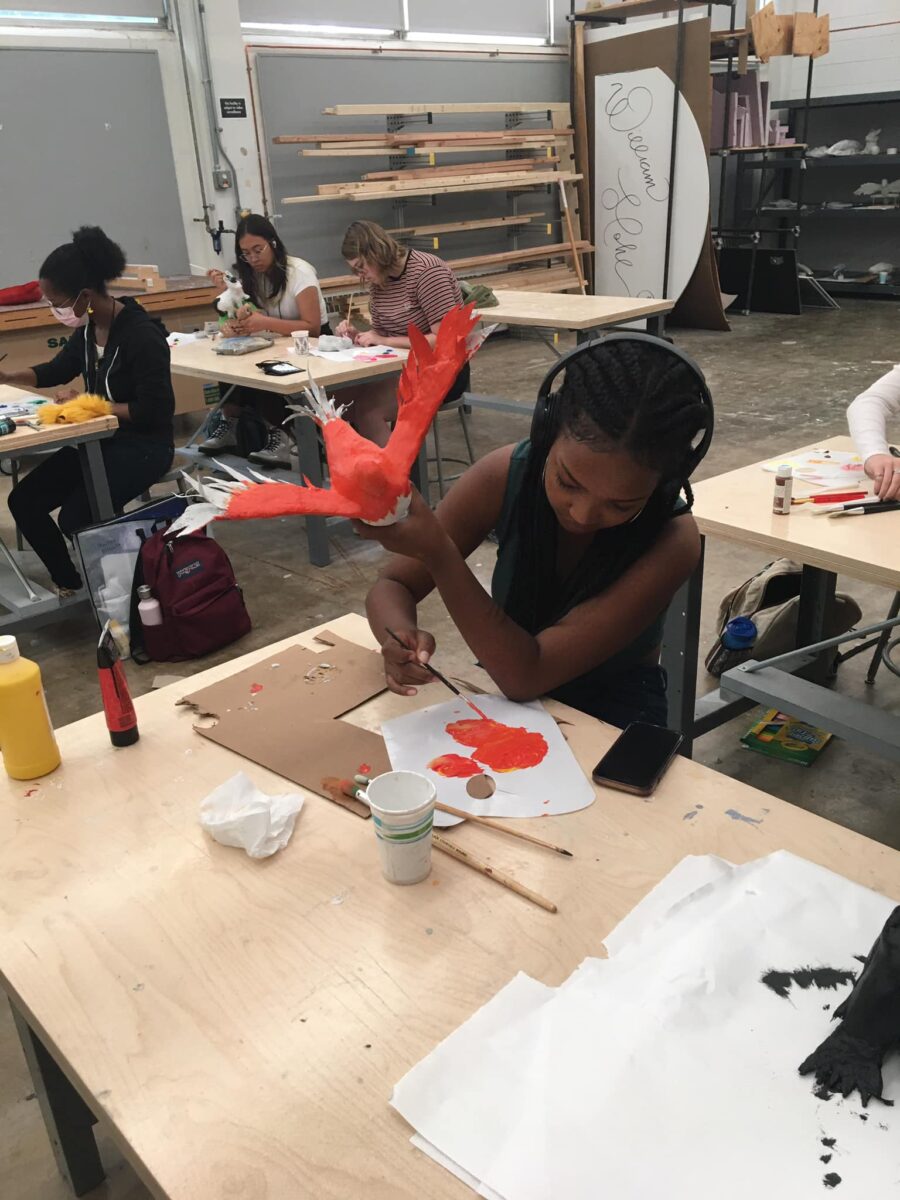 student paints a sculpture in studio