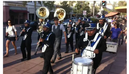 a marching band moves together down a walkway