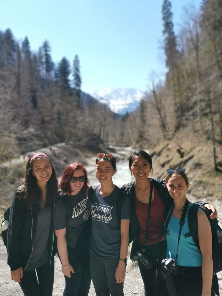 five students gathered in a forest