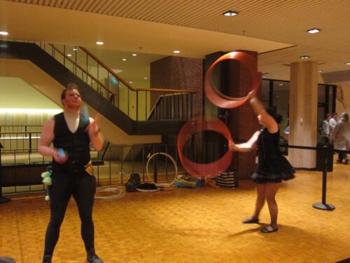 people juggling and throwing rings