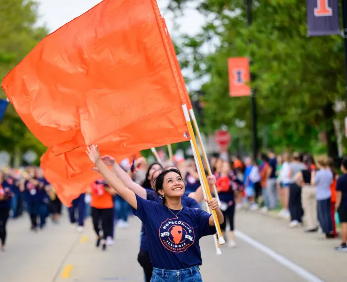 person waving flag in parade