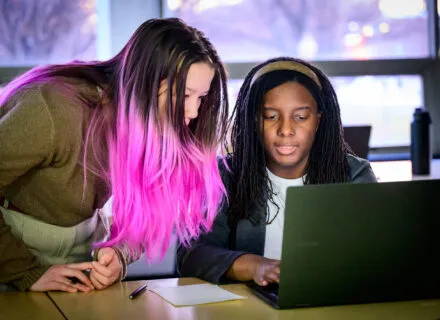 two students looking at computer