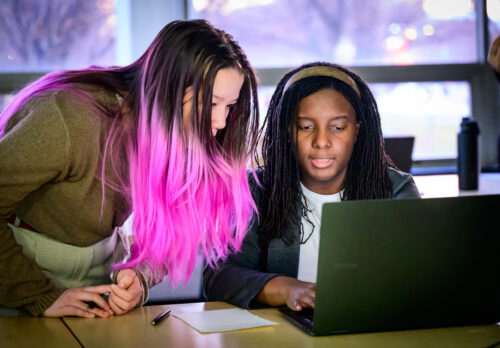 two students looking at computer