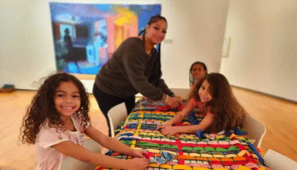 kids doing art activity smiling at camera