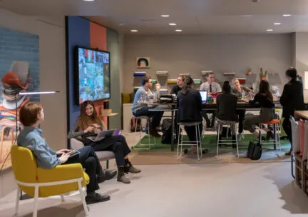 people in suits sitting around a table at a job fair