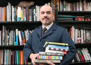 Photo of man with books