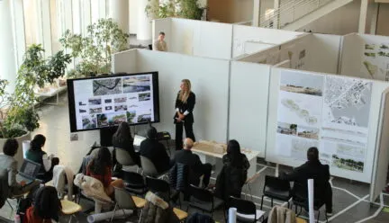 students gathered around big white boards