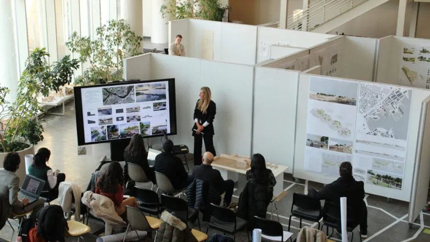students gathered around big white boards
