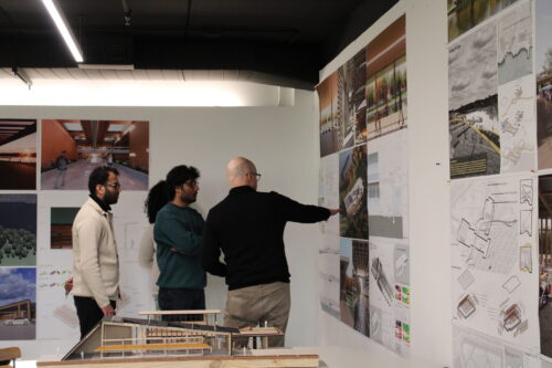 people gathered looking at posters