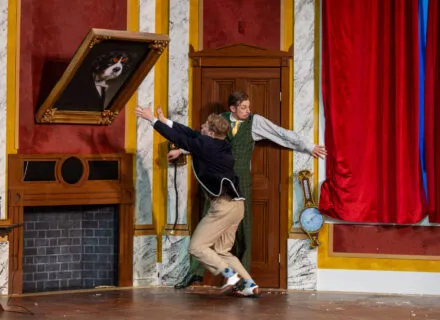 actor slides down a ramp onstage