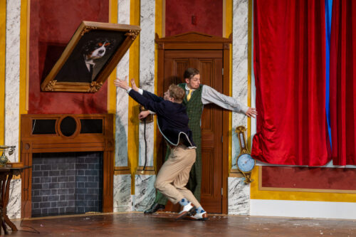 actor slides down a ramp onstage