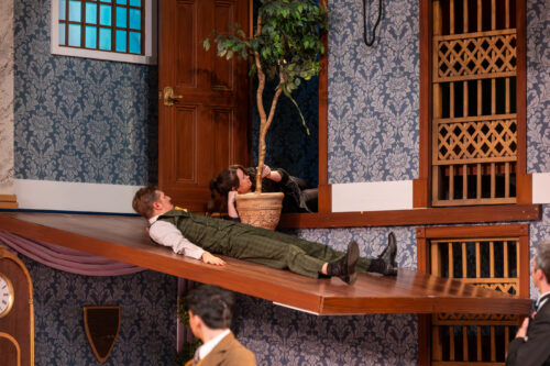 actor slides down stage ramp