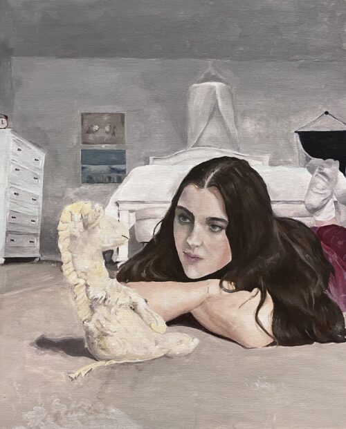 self-portrait of a person with long brown hair balanced on her elbows staring at a stuffed donkey in a bedroom
