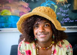 simmi wears yellow crochet sunhat and flowery top
