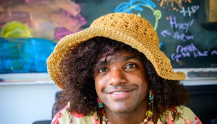 simmi wears yellow crochet sunhat and flowery top