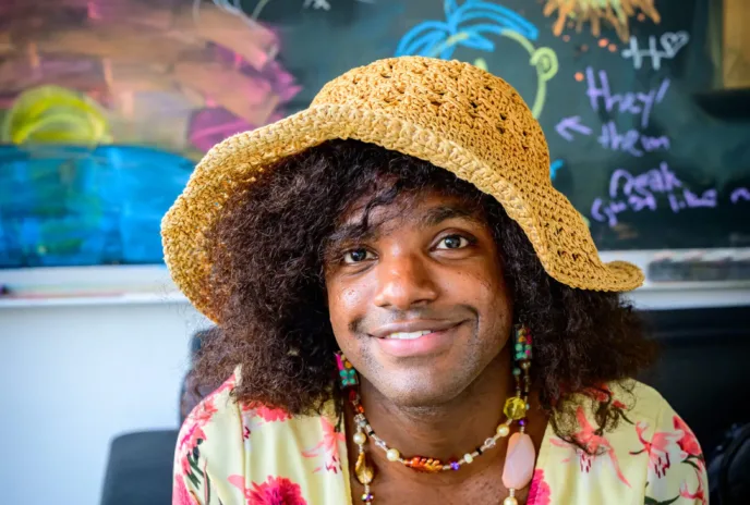 simmi wears yellow crochet sunhat and flowery top