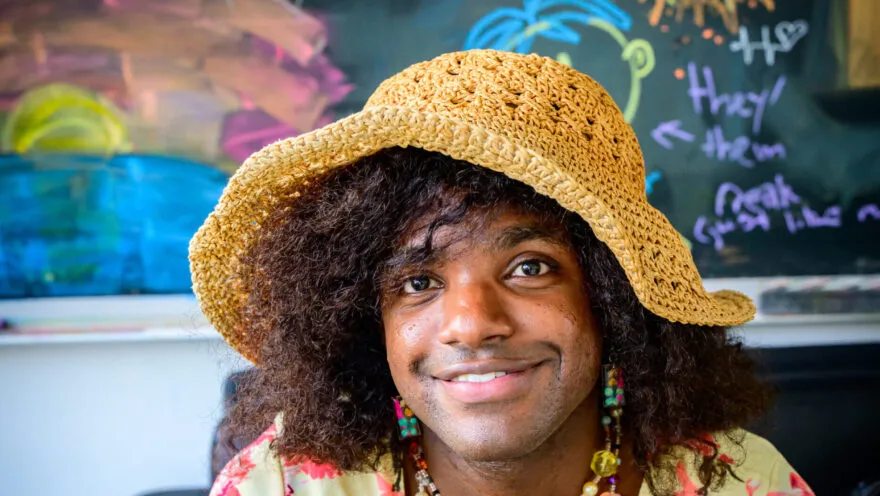 simmi wears yellow crochet sunhat and flowery top