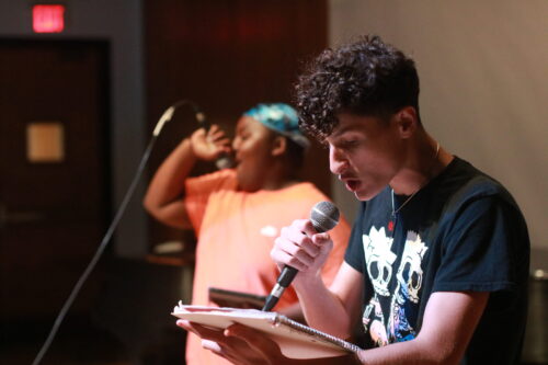 person sings into a mic
