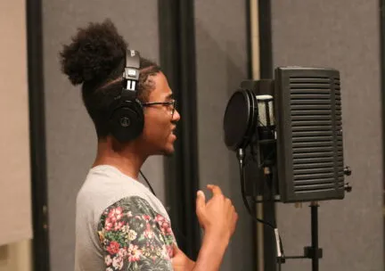 perosn singing into mic