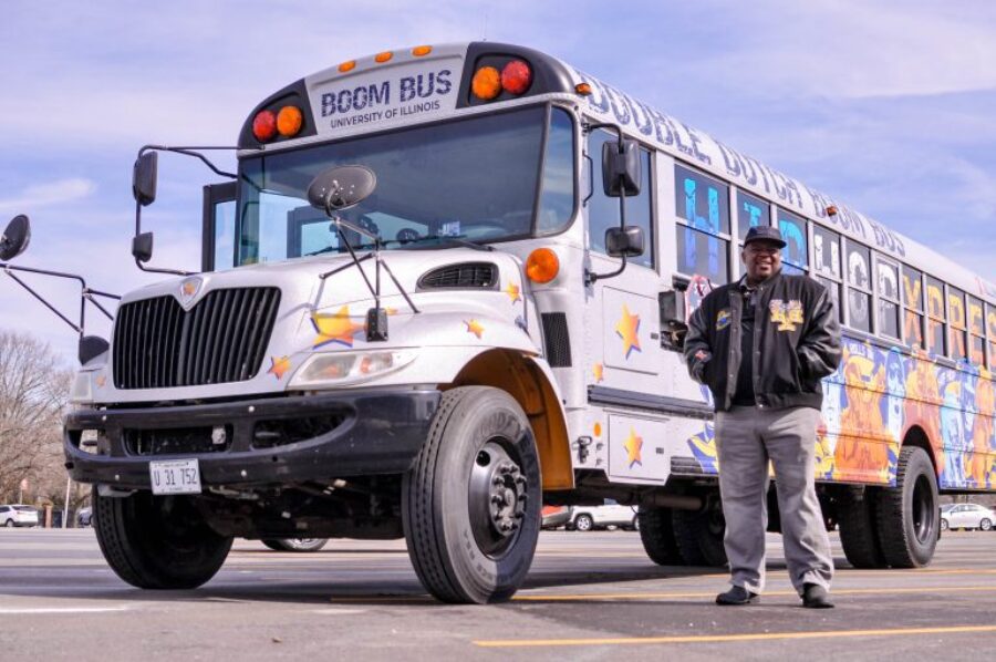a decorated school bus with a person standing in front of it