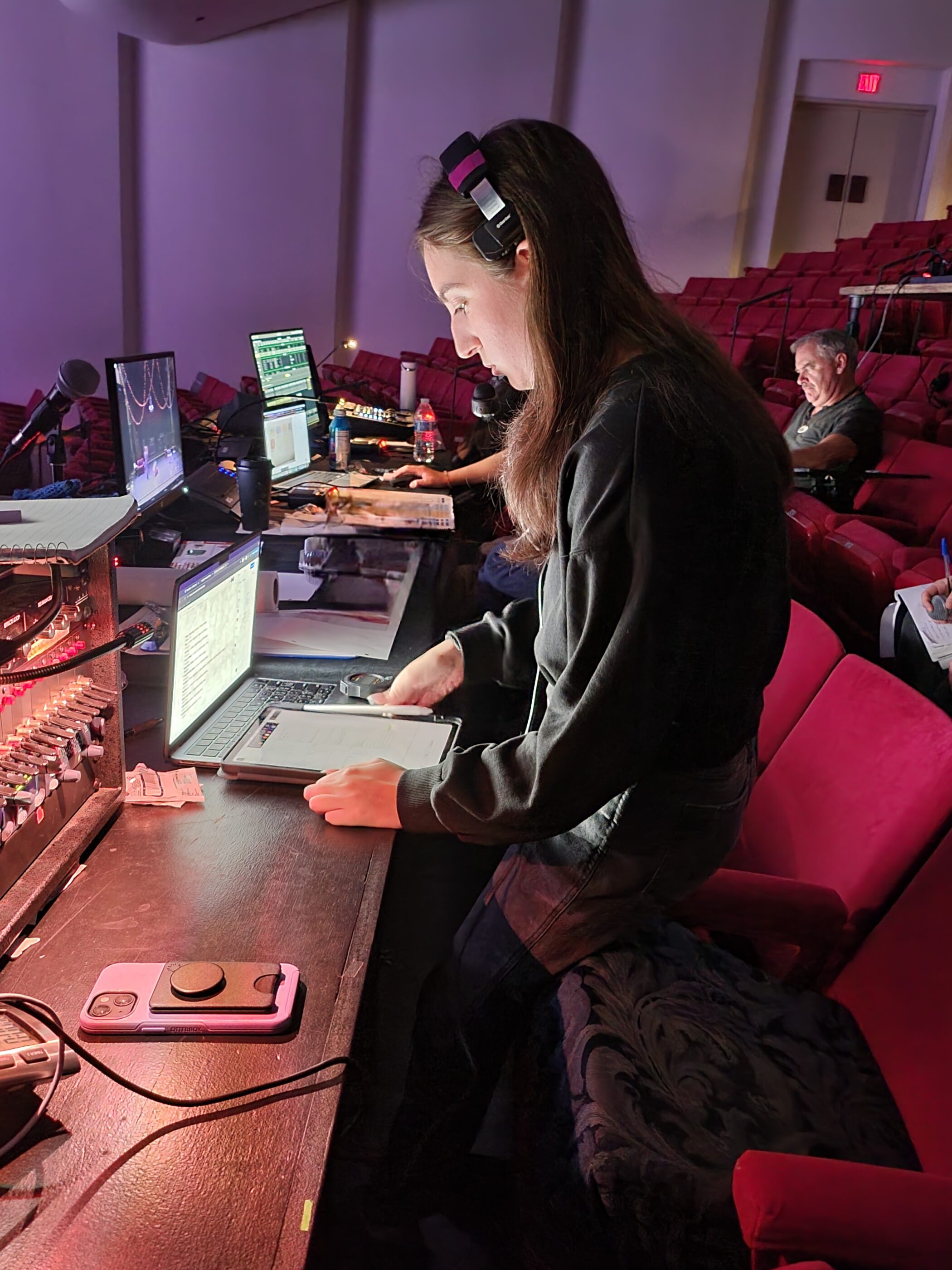 person at a tech table in a theatre
